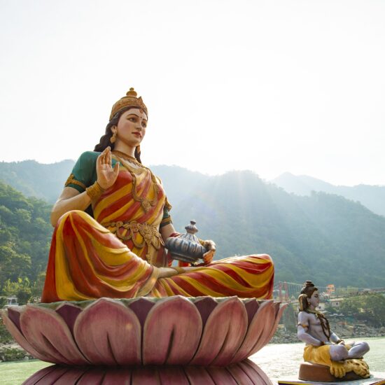 Stunning view of the statue of sitting Goddess Parvati and the statue of Lord Shiva on the riverbank of the Ganges river. Rishikesh, Uttarakhand, India