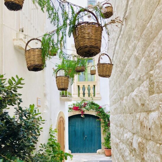 Wicker baskets hanging in the streets Of Polignano a mare, Puglia