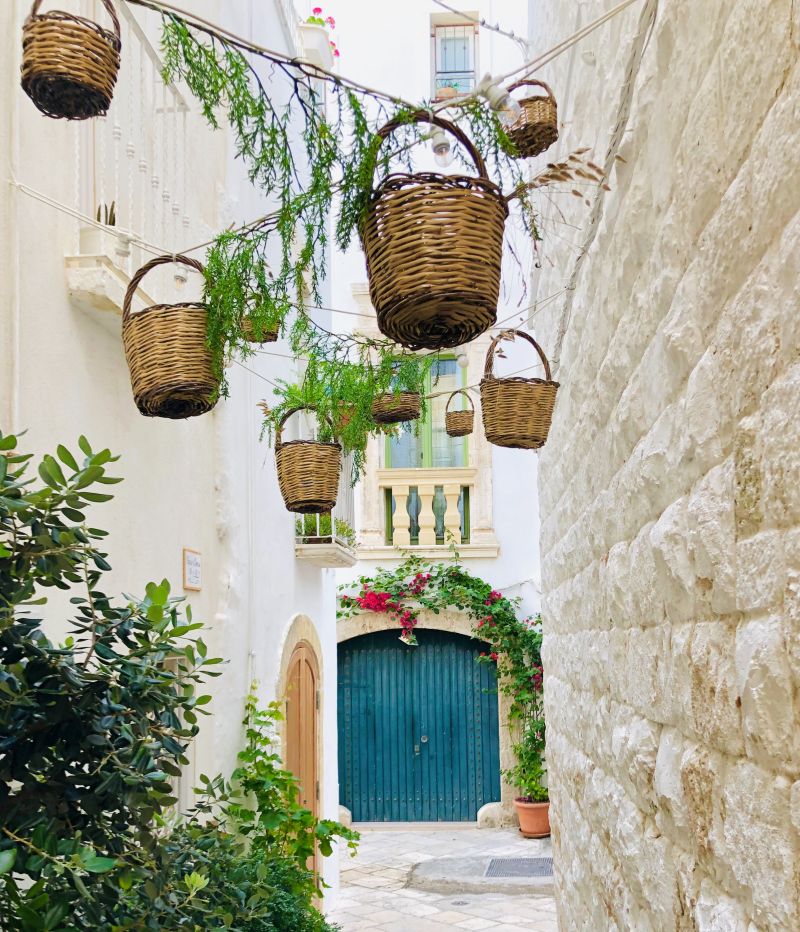 Wicker baskets hanging in the streets Of Polignano a mare, Puglia
