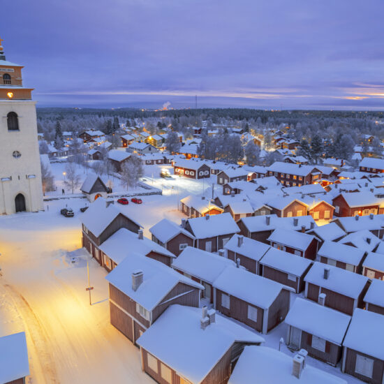 Gammelstad Church Town at dusk, aerial winter view, Sweden