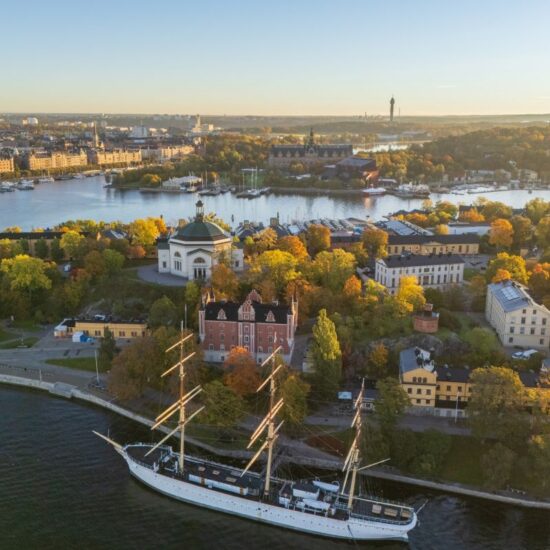 Skeppsholmen and Östermalm with Strandvägen in the background in autumn, morning warm sun, colorful trees, Stockholm, Sweden