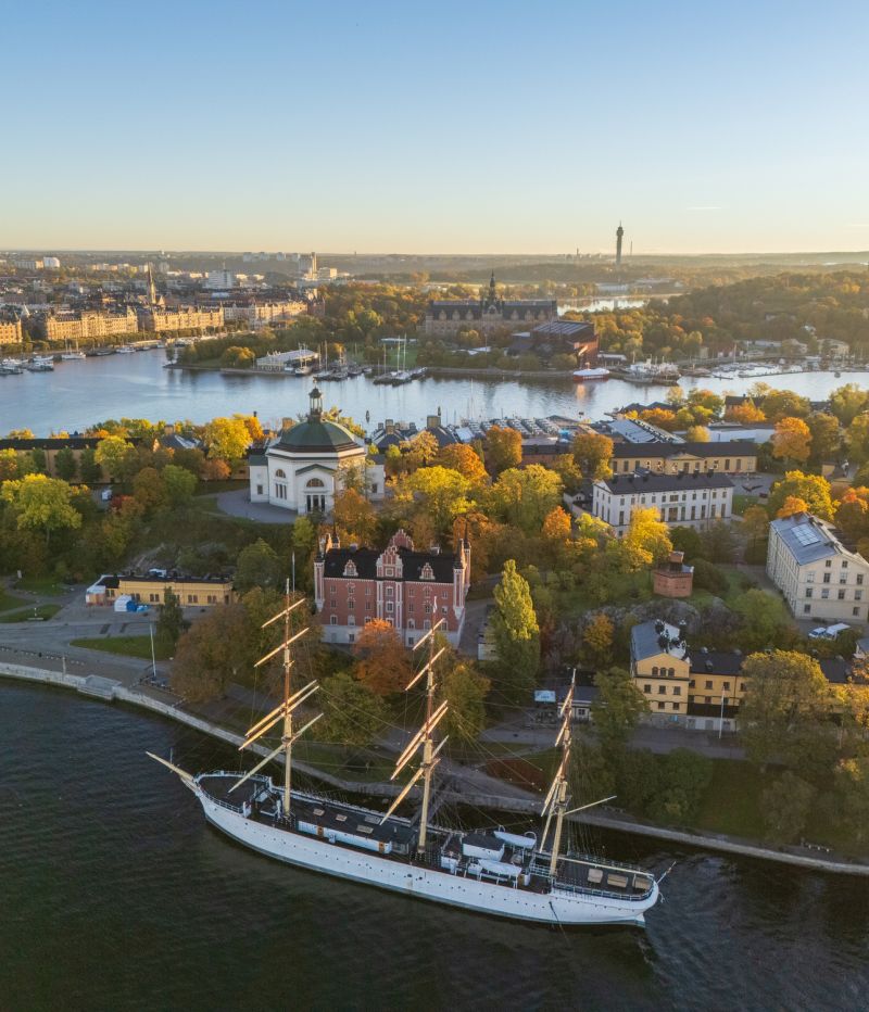 Skeppsholmen and Östermalm with Strandvägen in the background in autumn, morning warm sun, colorful trees, Stockholm, Sweden