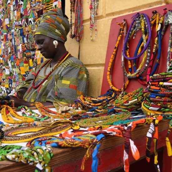 Mid Adult Woman Selling Colorful Personal Accessories At Market Stall