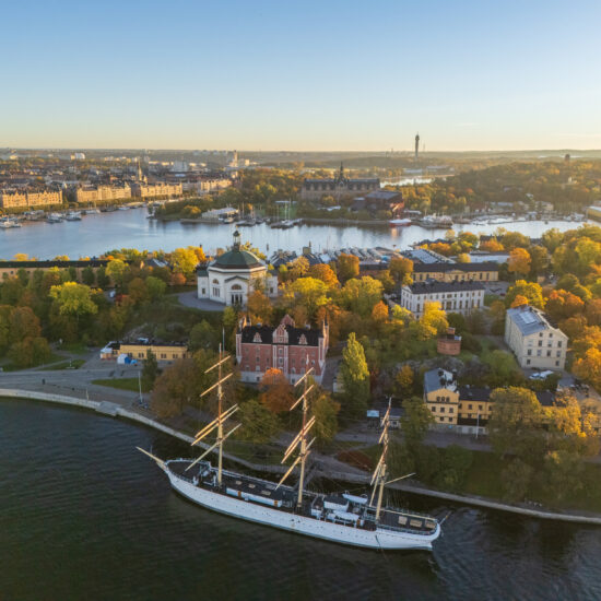 Skeppsholmen and Östermalm with Strandvägen in the background in autumn, morning warm sun, colorful trees, Stockholm, Sweden