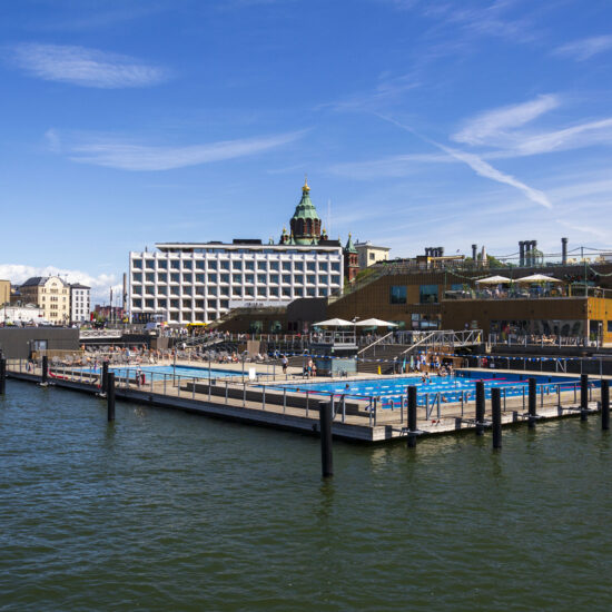 People enjoying public sea swimming pool and traditional sauna on sunny summer day in city center at Katajanokanlaituri on July 8, 2024 in Helsinki, Finland.
