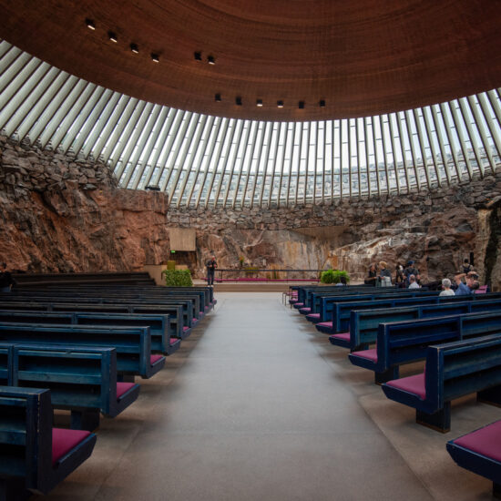 Interior view of temppeliaukio cave church with people sitting in pews helsinki, finland