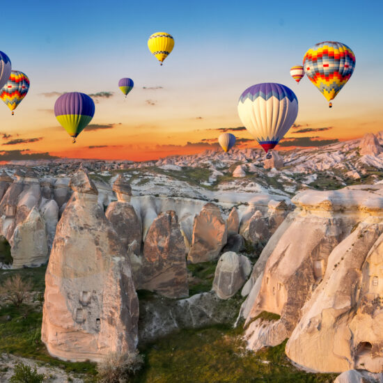 Hot air balloons at sunset over the cave town, Cappadocia, Turkey
